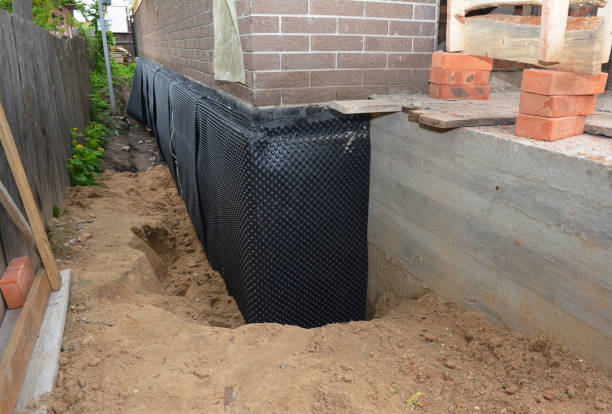 Happy homeowners after waterproofing job in Yoder